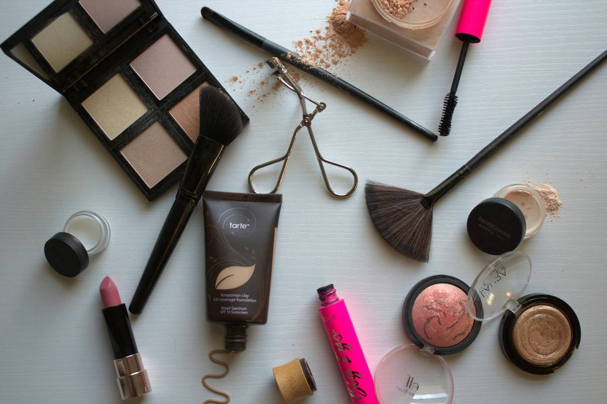 Woman applying cheap cosmetic product foundation in natural light showing seamless blend